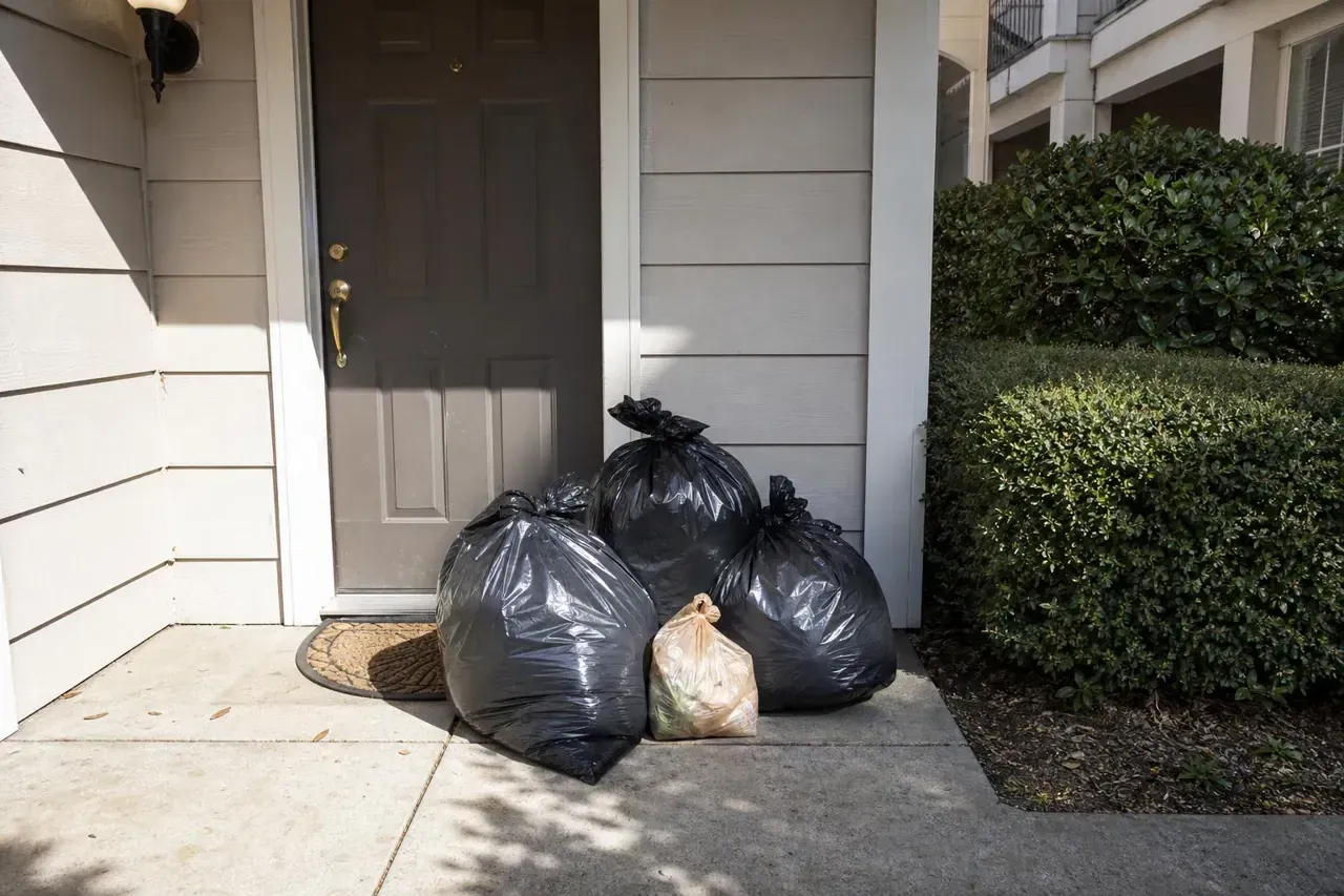 Sealed valet trash bins set out for doorstep collection